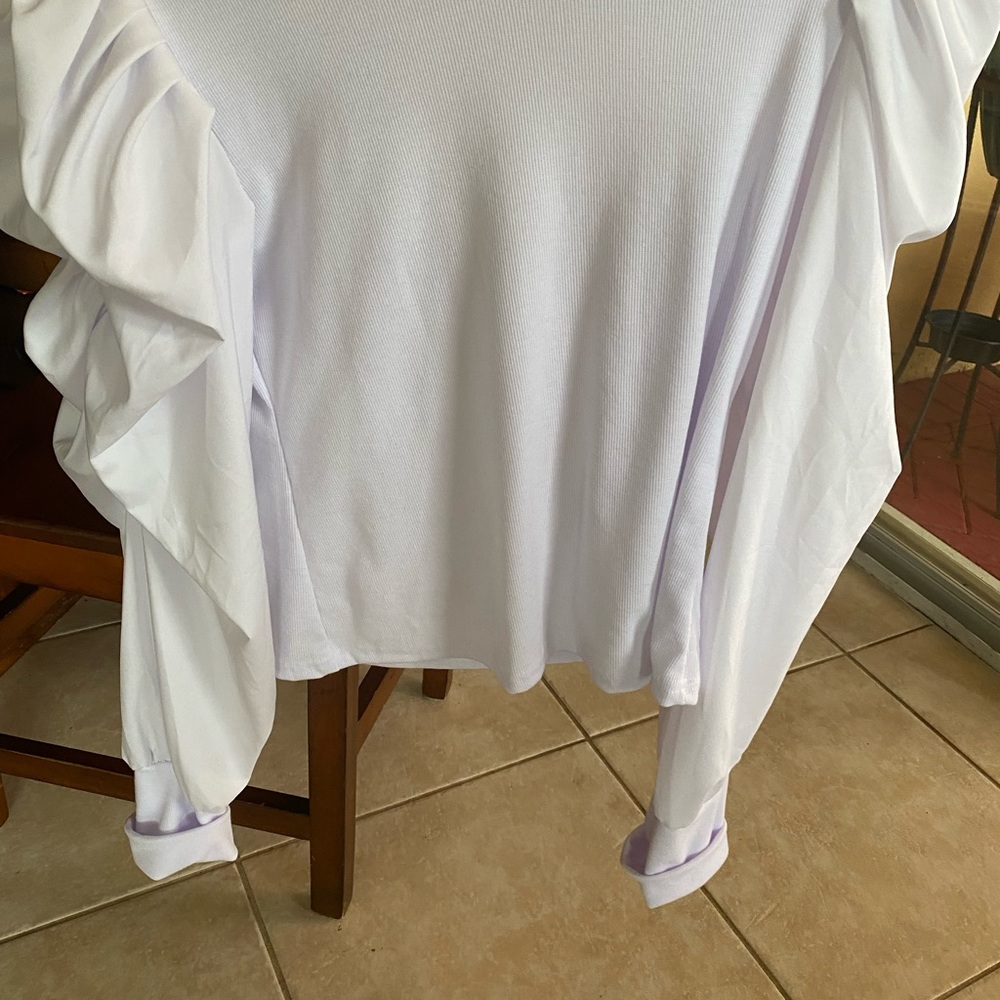 Brand new white ruffle shirt never been worn it does not suit me well